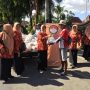 Ketua DWP Sumenep Chosnul Chotimah menyerahkan paket sembako kepada abang becak